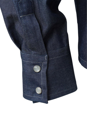 A close-up of a navy denim blouse featuring buttoned cuffs and a textured fabric. It has a brand logo.