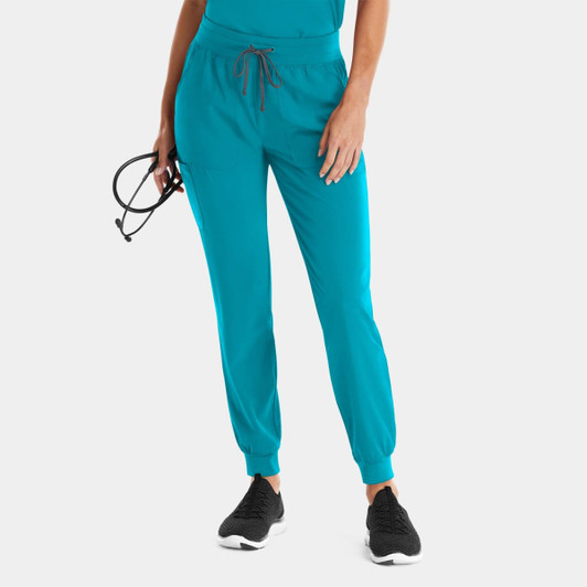 A pair of turquoise joggers with an elastic waistband, tapered fit, and drawstring detail, featuring a logo.