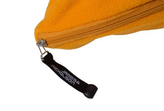 A yellow fleece blanket with a zip closure and a branded tag.