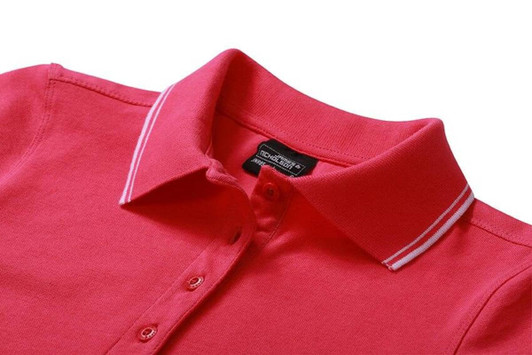 A pink ladies' polo shirt featuring a collar and buttoned placket, with a logo on the inside.
