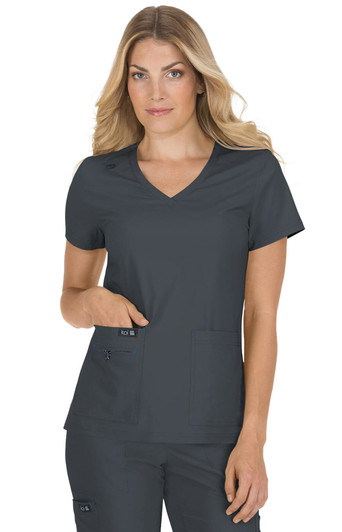 A grey scrubs top with a V-neck, featuring short sleeves and two front pockets, worn by a model.
