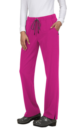A pair of bright pink pants with a drawstring waist and pockets, worn by a model in a white top.