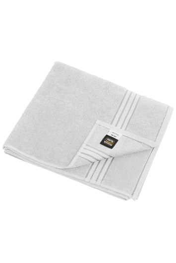 A soft grey bath towel folded neatly, featuring a subtle striped design and a logo on the corner.