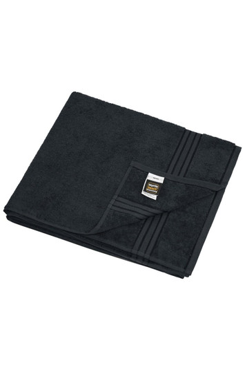 A black sauna sheet with a textured surface, neatly folded with a label in the corner.