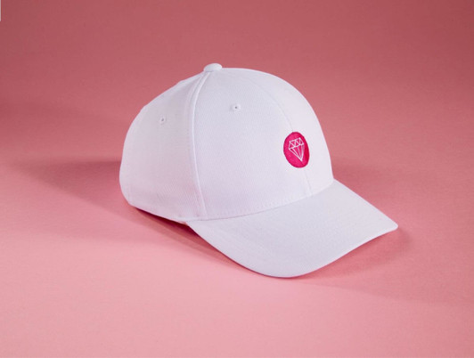 A white Flexfit® cap featuring a vibrant pink logo, set against a pink background.
