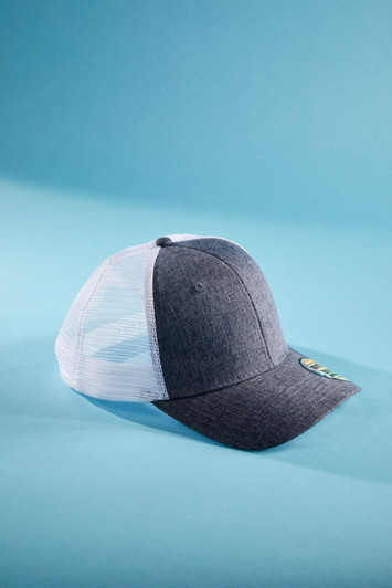 A grey 6-panel cap with a mesh back, featuring a logo on the side, set against a blue background.