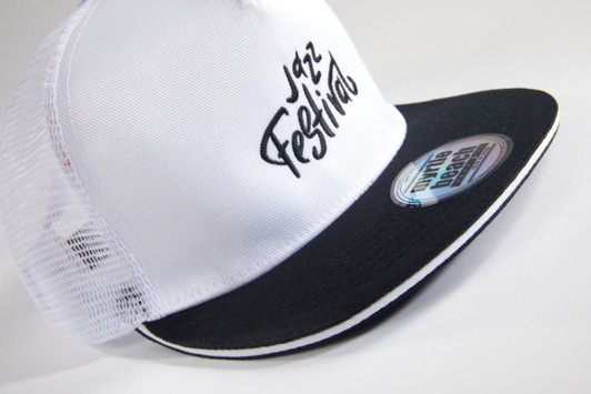 A white and black trucker cap featuring a mesh back and a curved brim, with a logo on the front.
