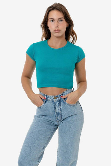 A fitted turquoise cap sleeve crop top displayed on a model, paired with high-waisted blue jeans.