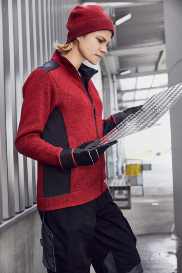 A red knitted fleece workwear beanie is worn by a person holding a map, dressed in a matching red fleece top and gloves.