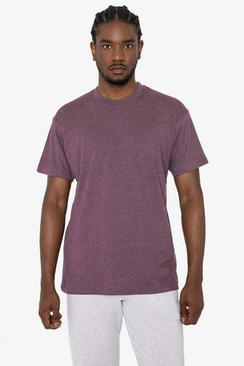 A short sleeve cotton-poly crew tee in a rich burgundy colour, worn by a model with braids. Features a branding logo.