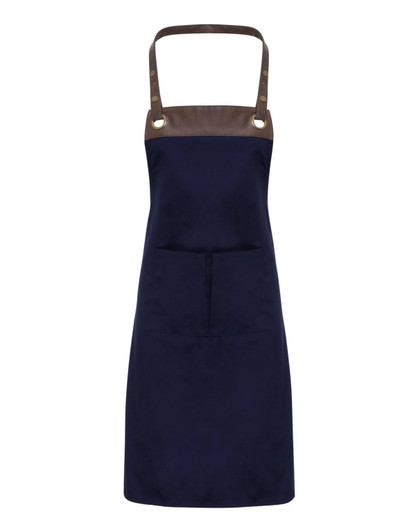 A navy blue apron with a brown top section and a central pocket, featuring metallic rivets. It has a logo on it.