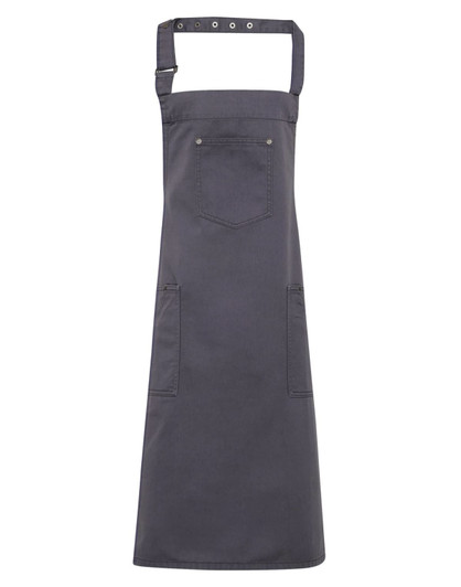 A dark grey Chino Cotton Bib Apron with pockets and a neck strap, featuring a logo.