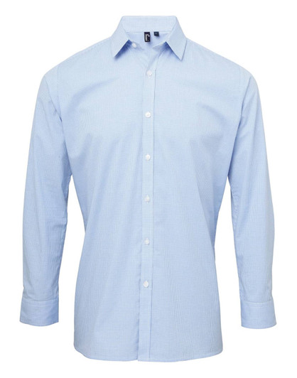 A light blue button-up shirt with long sleeves and a collar, featuring a logo on the chest.