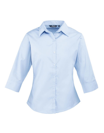 A light blue women's 3/4 sleeve poplin blouse with a button-up front and a collar. It features a logo on the label.