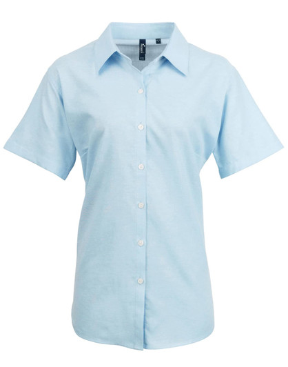 Light blue women's short-sleeve button-up shirt with a collar and a logo on the chest.