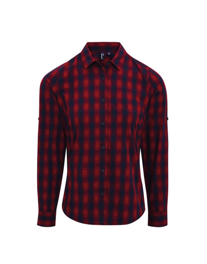 A check-patterned button-up shirt in red and navy, featuring long sleeves and a brand logo.