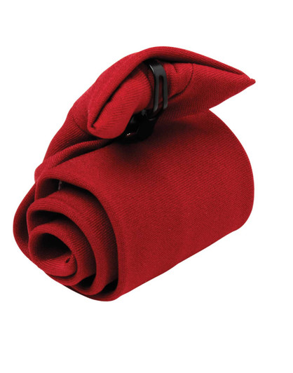 A red tie is neatly rolled and secured with a black clip. The fabric has a textured appearance.