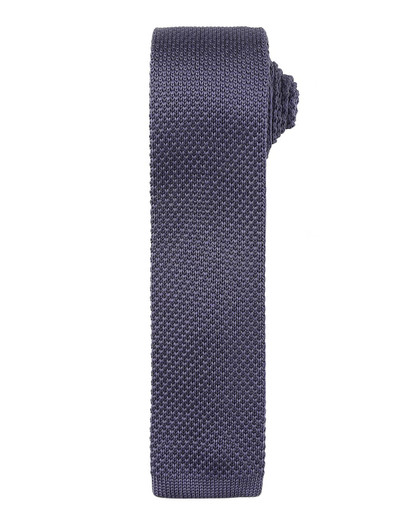 A slim knitted tie in a dark navy colour with a textured pattern, featuring a branding logo.