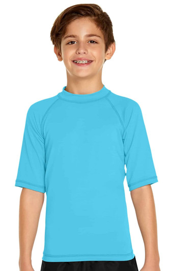 A boy smiles while wearing a bright blue short sleeve rashie with a high collar and raglan sleeves.