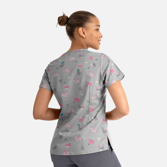 A grey women's V-neck top featuring a playful pattern of colourful cats and accessories, with a logo present.
