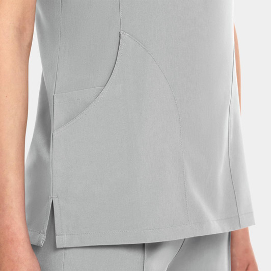 A women's V-neck top in light grey featuring a stylish design and a side pocket. It has a simple branding logo.