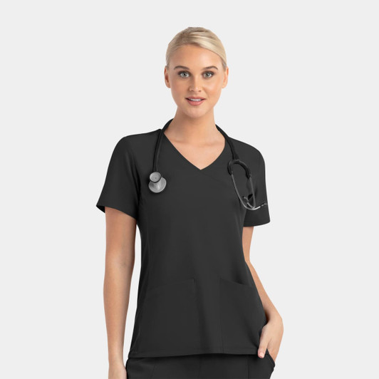 A woman wearing a black mock wrap top with contrast panels, featuring a stethoscope around her neck.