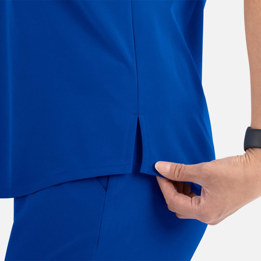 A blue women's v-neck top with a tuckable design, featuring a side slit.