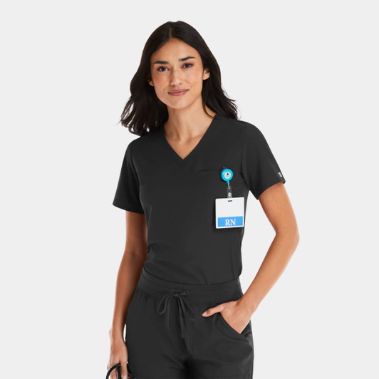 A women's black V-neck top with a pocket, worn with a badge holder. The top has a logo on it.