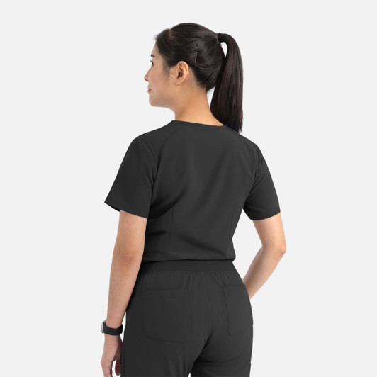 A women's tuckable V-neck top in black, featuring a simple design with short sleeves and a back view.