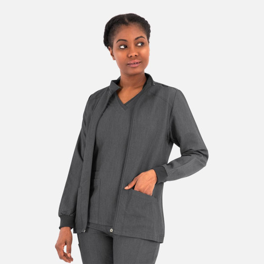 A women's hi collar warm-up jacket in black, featuring a zip front and pockets, modelled by a woman.