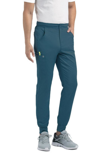 Teal jogger pants with a half elastic waistband and side pockets, worn by a model in a casual outfit.