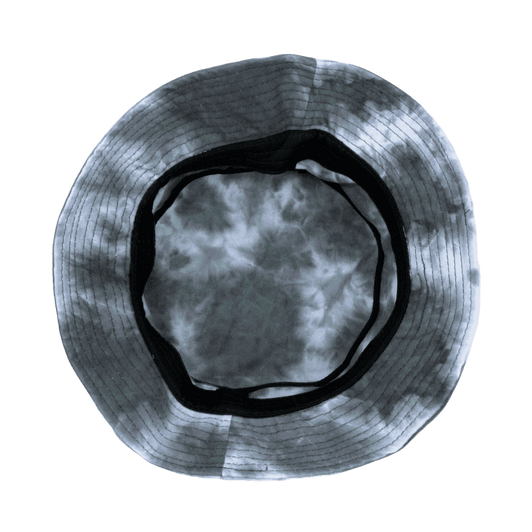 A tie dye bucket hat featuring shades of grey and black, with a black interior lining and a round shape.