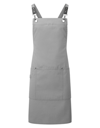 A grey cross-back bib apron featuring adjustable straps and a front pocket, with a logo present.