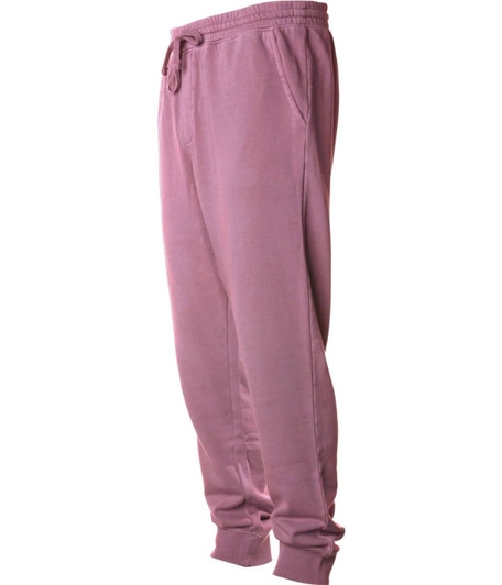 A pair of men's pigment dye sweatpants in a soft mauve colour with pockets and an elastic waistband.