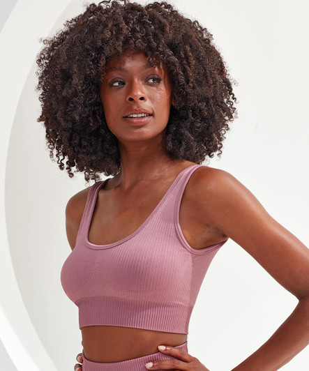 A ribbed, seamless sport bra in a soft mauve hue, featuring a fitted design and wide straps.