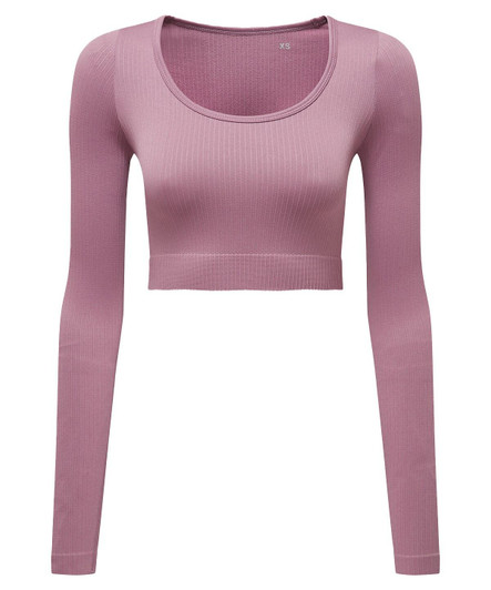 A ribbed seamless crop top in light pink with long sleeves and a round neckline, featuring a logo.