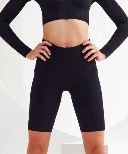 Ribbed seamless 3D fit cycle shorts in black, featuring a high waistband and side pockets, displayed on a model.