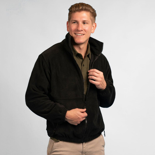 A black full zip polar fleece jacket worn by a smiling man, featuring a collar and zipped pockets.