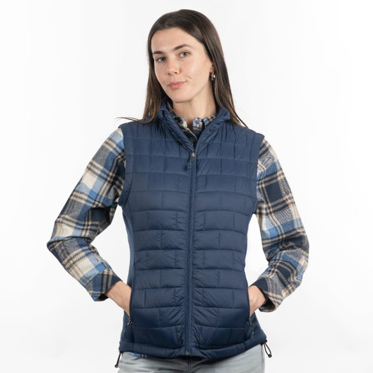 A navy quilted puffer vest is worn over a checked shirt, featuring a zipper and side pockets.