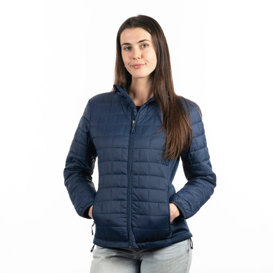 A woman wearing a navy quilted puffer jacket with a zip front and side pockets, featuring a logo.