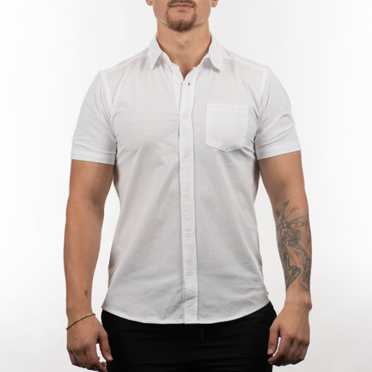 A short sleeve shirt in white, featuring a front pocket and a logo on the chest area.