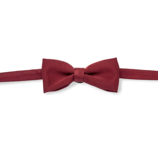 A burgundy bow tie with a smooth finish and adjustable strap. It features a logo on the label.