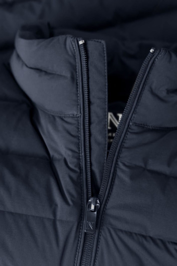 A navy blue women's down jacket with a zippered front and a hood. The fabric has a quilted texture.