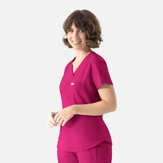 A model wearing a fuchsia Y-neck top with short sleeves and a front pocket, featuring a logo.
