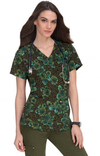 A floral print scrub top featuring dark brown and green hues, worn by a model with a stethoscope.