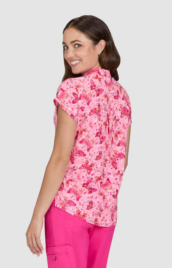 A short-sleeved shirt in pink featuring a butterfly print, with a round collar and a branded logo.