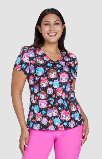 A colourful women's top featuring a pattern of cartoon-style faces in shades of pink, blue, and purple. It has a v-neck design.