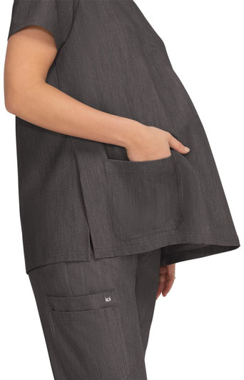 A grey maternity top featuring a pocket, designed for comfort with a loose fit for expectant mothers.