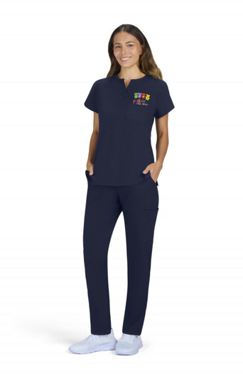 A woman wearing a navy placement top and matching pants, with pockets and a colourful logo on the top.
