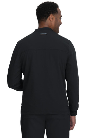 A man wearing a black jacket viewed from the back, featuring a simple design and a logo.